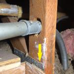 Someone drilled a hole through the upright of this truss to install a conduit for some electrical circuits. The steel web, (yellow arrow) indicates this is a 'truss', and not a conventional framing member. Trusses are engineered for a specific load capability and shall NEVER be altered in any way.